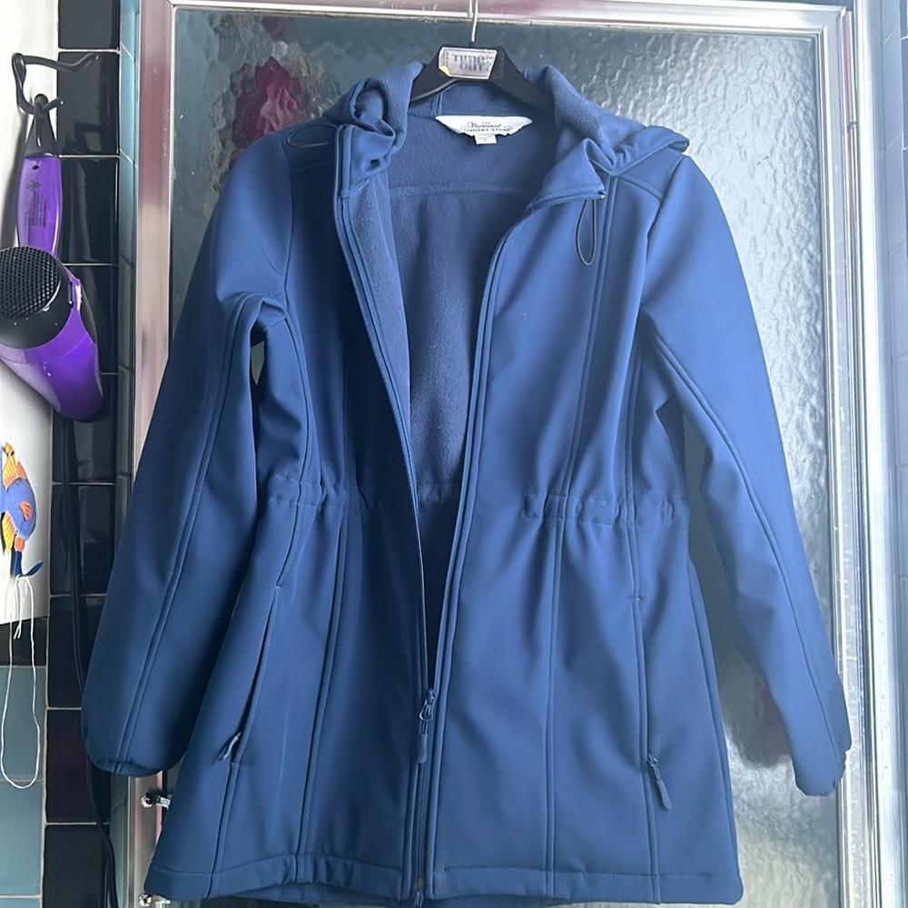 Women’s wind resistant shell with fleece lining.